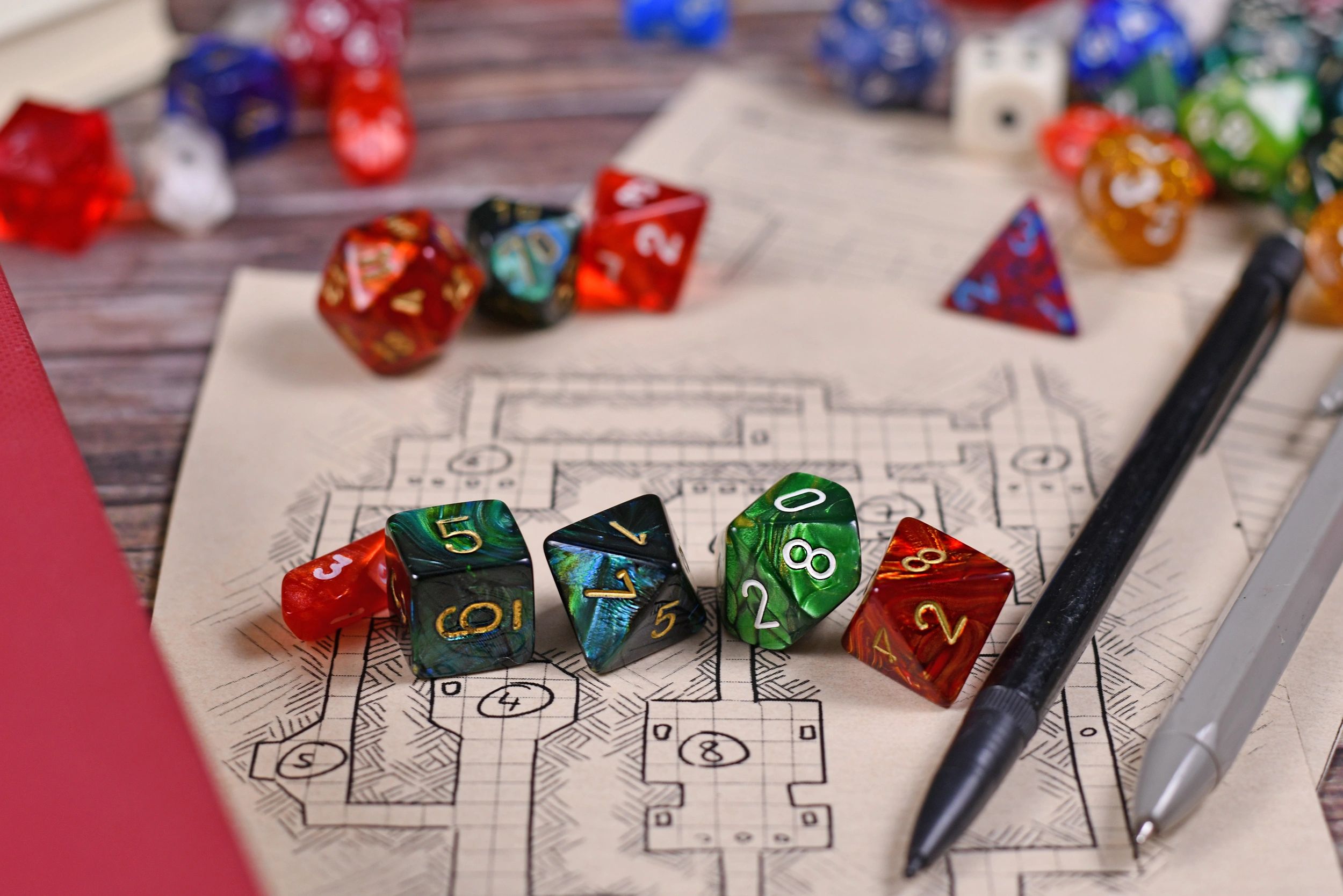 Colorful RPG dice on a hand-drawn dungeon map representing tabletop play