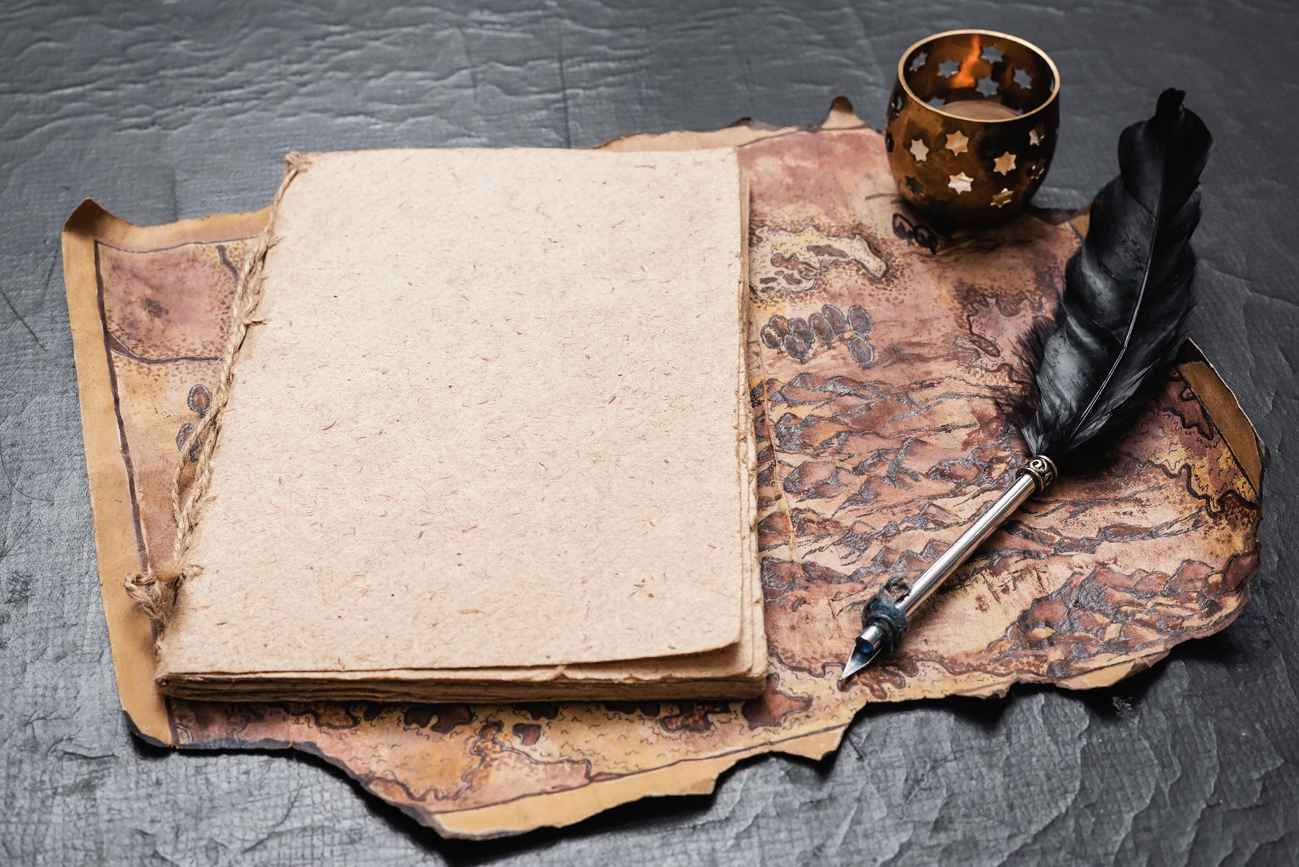 Open adventurer journal and map on a dark table, representing campaign notes